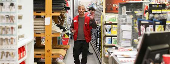A hardware store employee waves