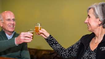 Peter Welch and Liz Gamache toast glasses of beer