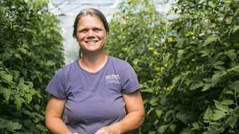 Christa Alexander smiles in one of her greenhouses
