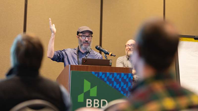 One of the speakers talking into a microphone during their session