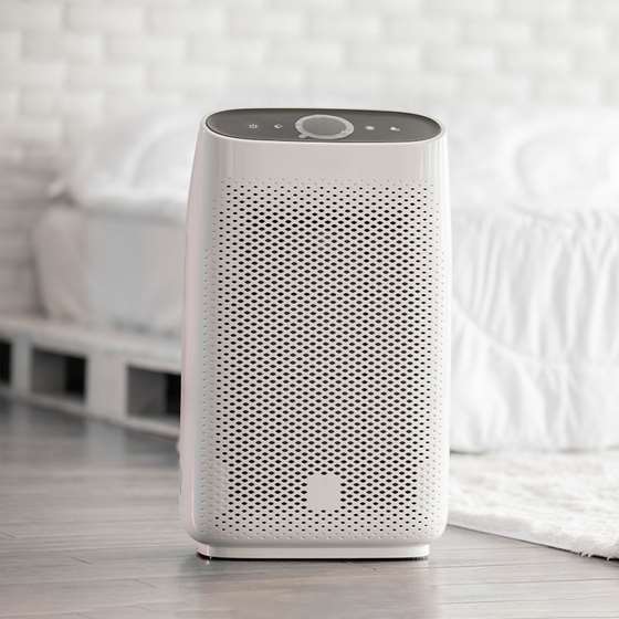 a white appliance that looks similar to an electric space heater in a bedroom setting