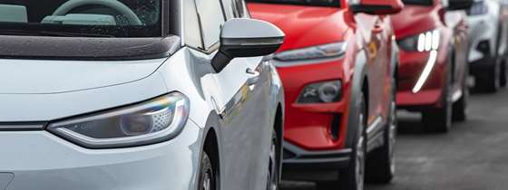 New EVs  in a line of traffic or sitting on a car dealers lot