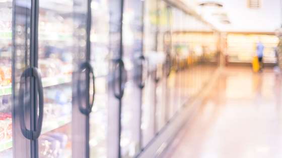 Grocery store aisle of refrigerated cases