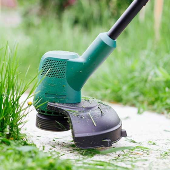 an electric trimmer in grass