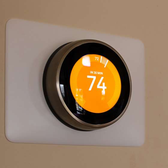 A smart thermostat on a wall