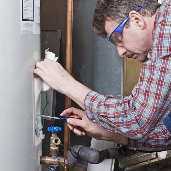 A man tunes a furnace