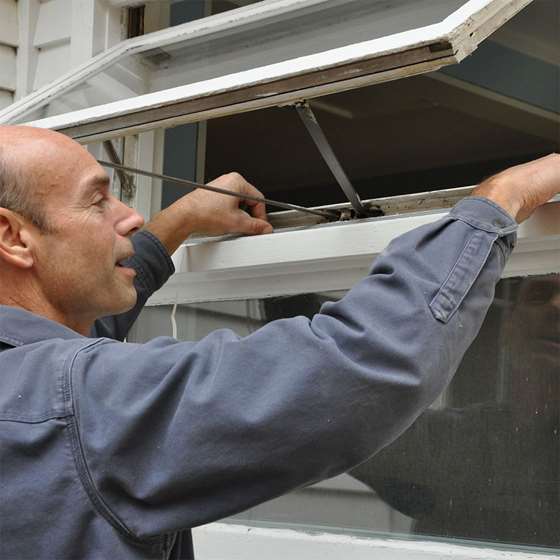 A man fixes an open window