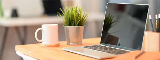 Image of open laptop computer on a desk symbolizing energy use at the office.