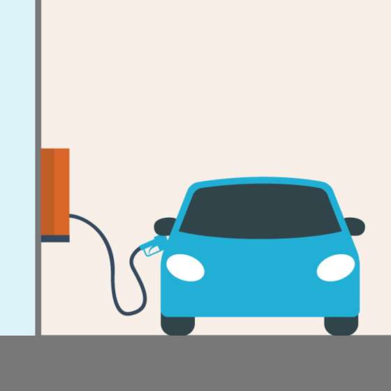 blue care plugged into a charger mounted on a wall