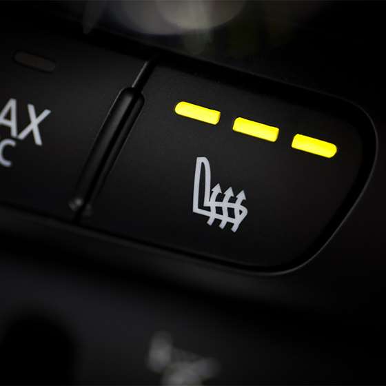 button on car dashboard showing icon for car seat heater