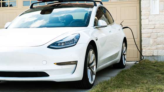 Electric vehicle charging in front of a garage