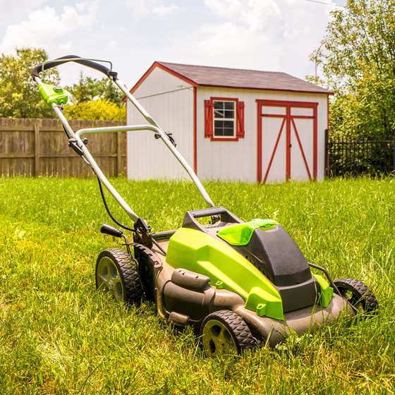 An electric lawn mower in a lawn
