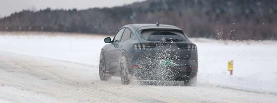 an electric vehicle driving in snowy conditions 