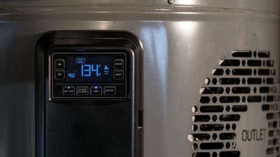 close up photo of a heat pump water heater control panel with a digital display that reads 134F
