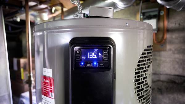 close up of a heat pump water heater with a digital display that reads 135
