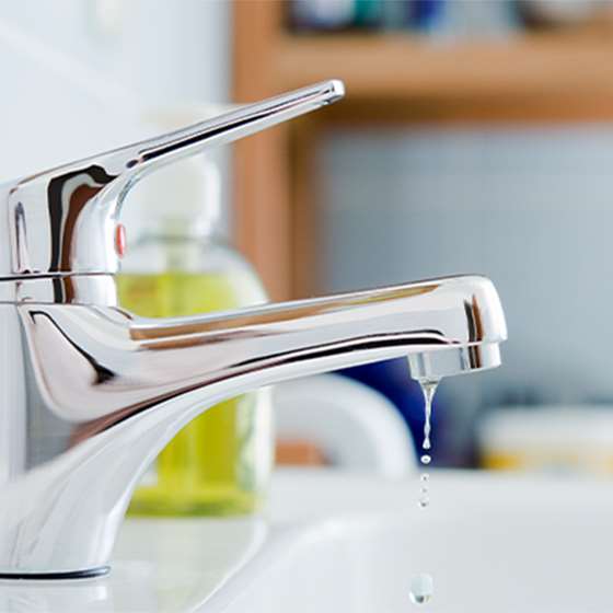 small chrome bathroom faucet dripping