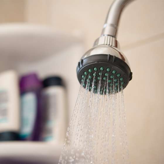 close up of a shower head with running water