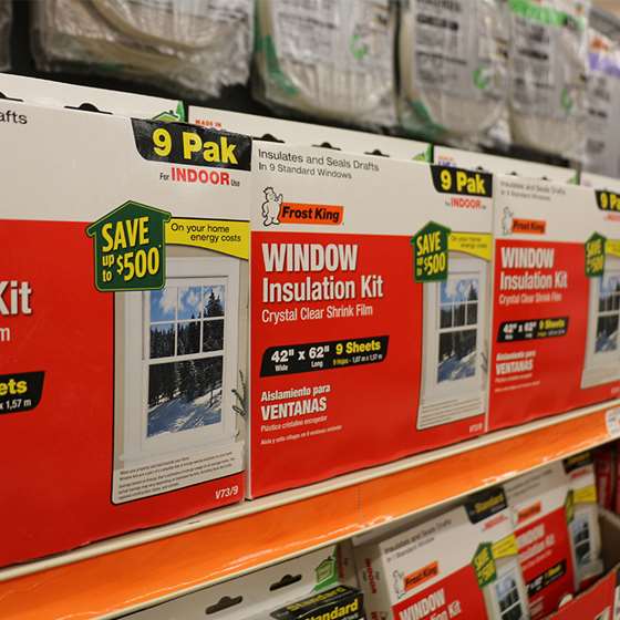 red and white packaging of DIY weather stripping on a store shelf
