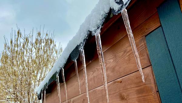 a home in winter with icicles