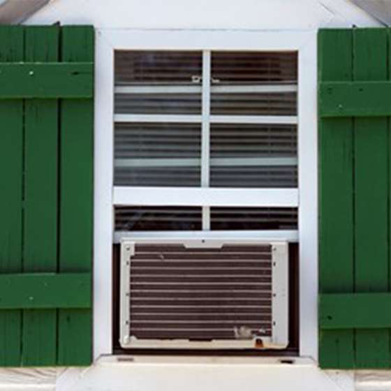 Image of a window air conditioning unit in the window of a house