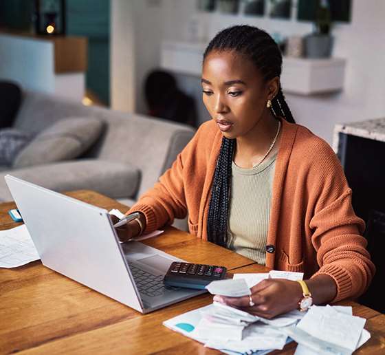 Woman managing finances with a calculator