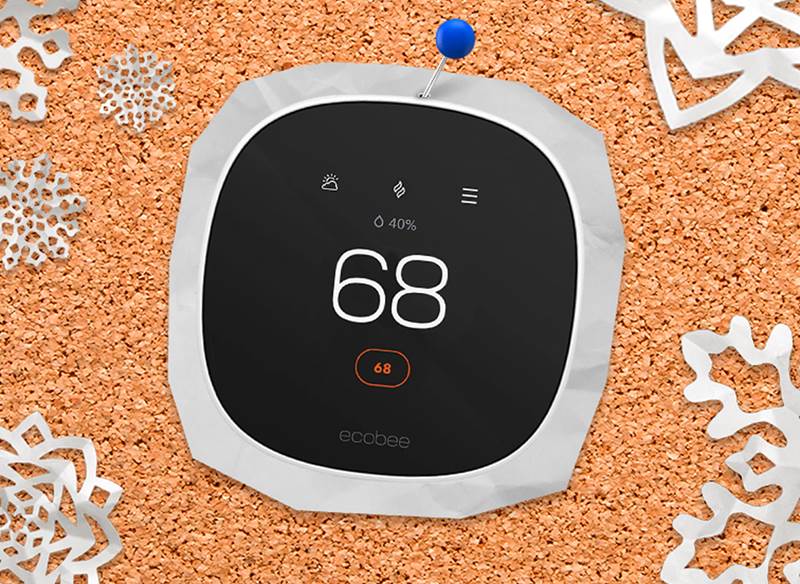 A corkboard with a picture of a thermostat pinned to it
