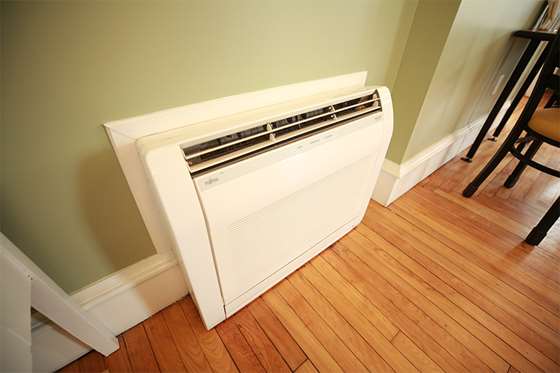 heat pump unit inside showing hardwood floors of an older building