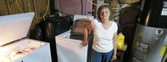 Gloria Powers stands next to her new efficient appliances