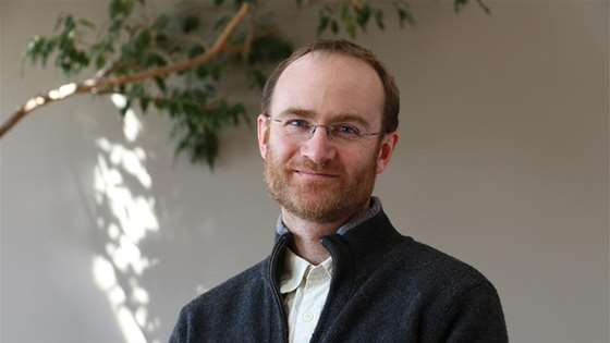 man in gray shirt and glasses