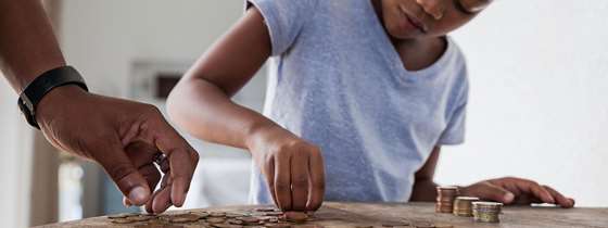 Girl counts money on a table
