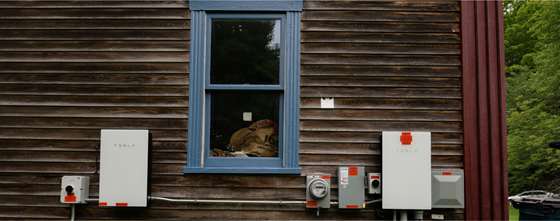 exterior of a home showing electrical updates and Tesla Powerwall