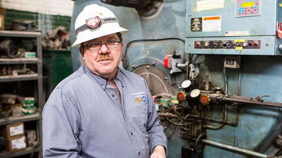 Dan Turcotte stands near machinery in the Blue Seal warehouse
