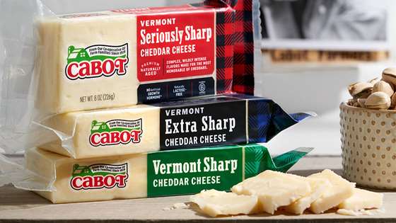Three blocks of Cabot cheddar cheese