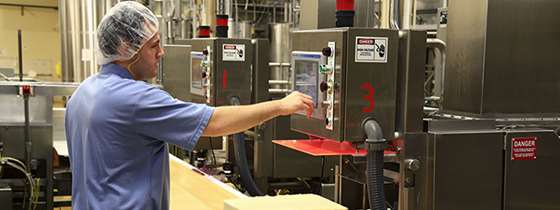 A worker adjusts equipment in the Cabot plant