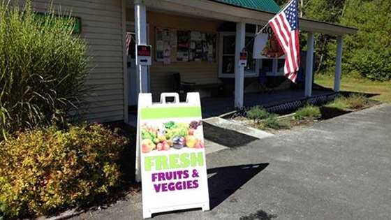 A sign outside the food shelf advertises fresh food