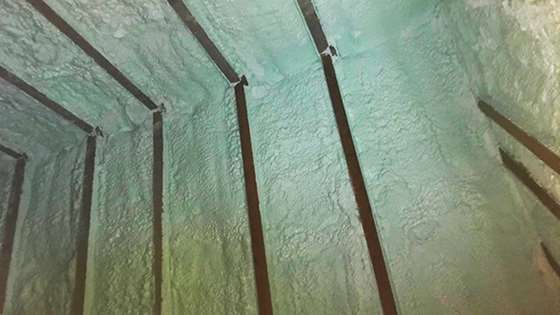 The interior eave of the attic covered in spray foam insulation