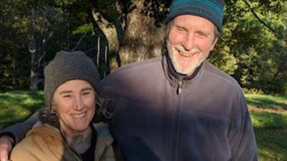 Jill and Flynn standing together and smiling outside