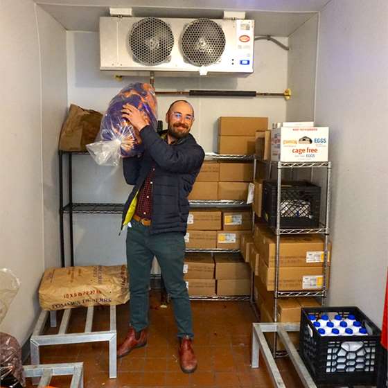man in walk in refrigeration unit