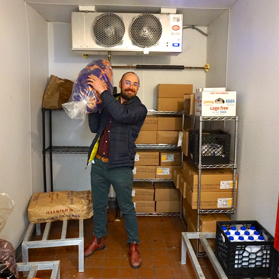 man in walk in refrigeration unit
