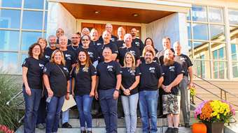 photo of Carris Reels employees posing for a group photo in matching shirts