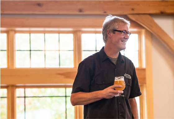 Sean Lawson holding a glass of beer 
