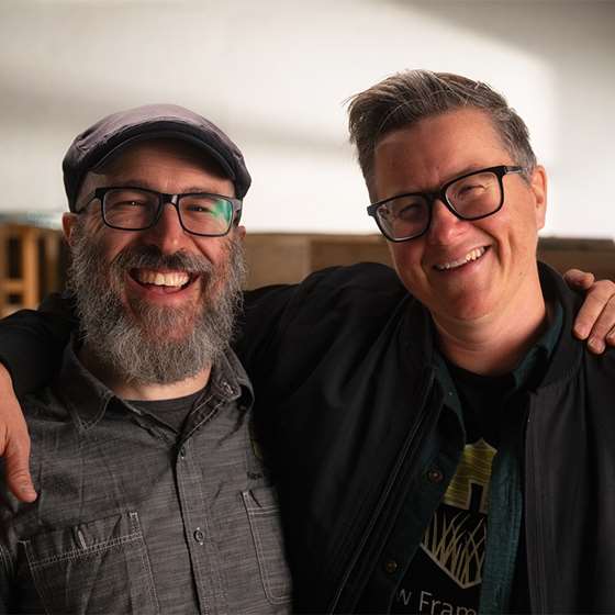 2 smiling men with glasses- Jacob Deva Rascusin (left) and Ace McArleton of New Frameworks