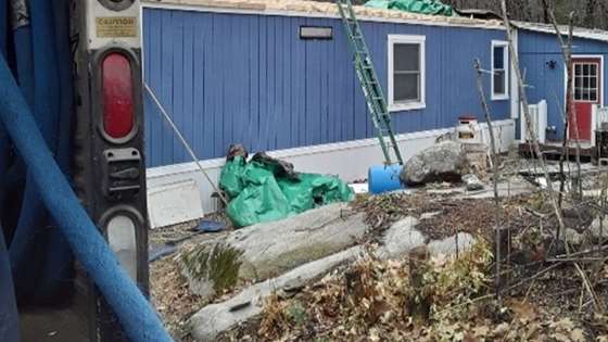 An exterior view of Eva's home with the roof replacement in progress