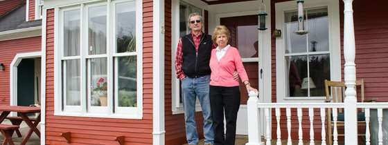 Lynn and Buddy stand on their porch