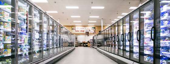 photo looking down the refrigeration aisle with frozen premade meals on the left and frozen vegetables on the right