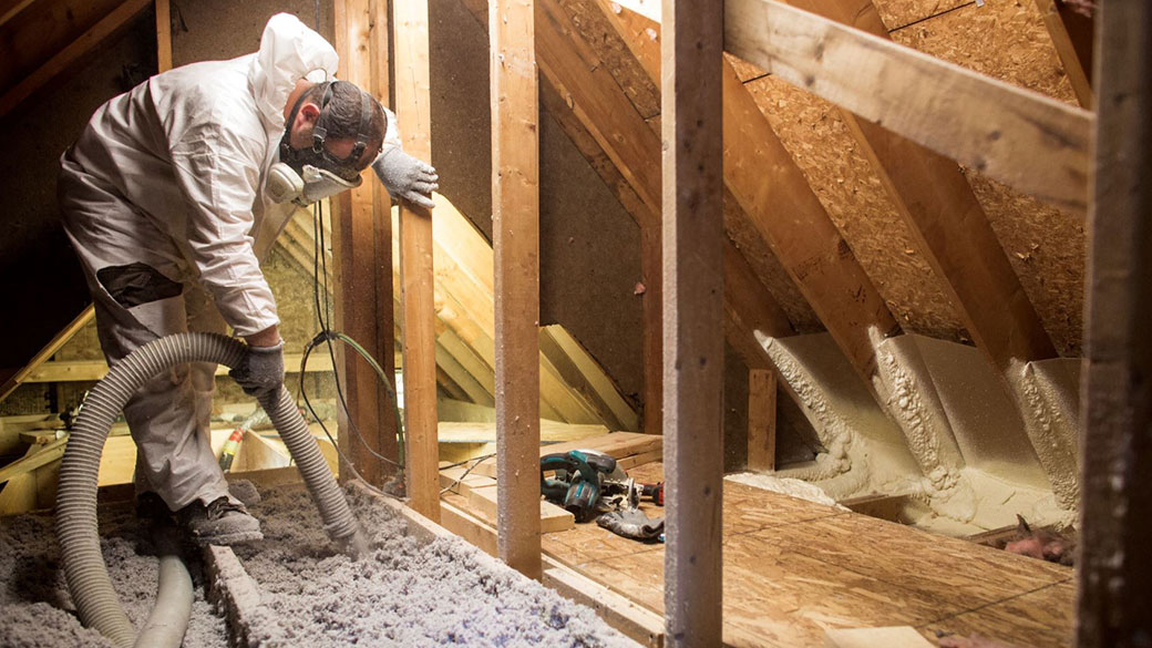 Contractor blowing insulation