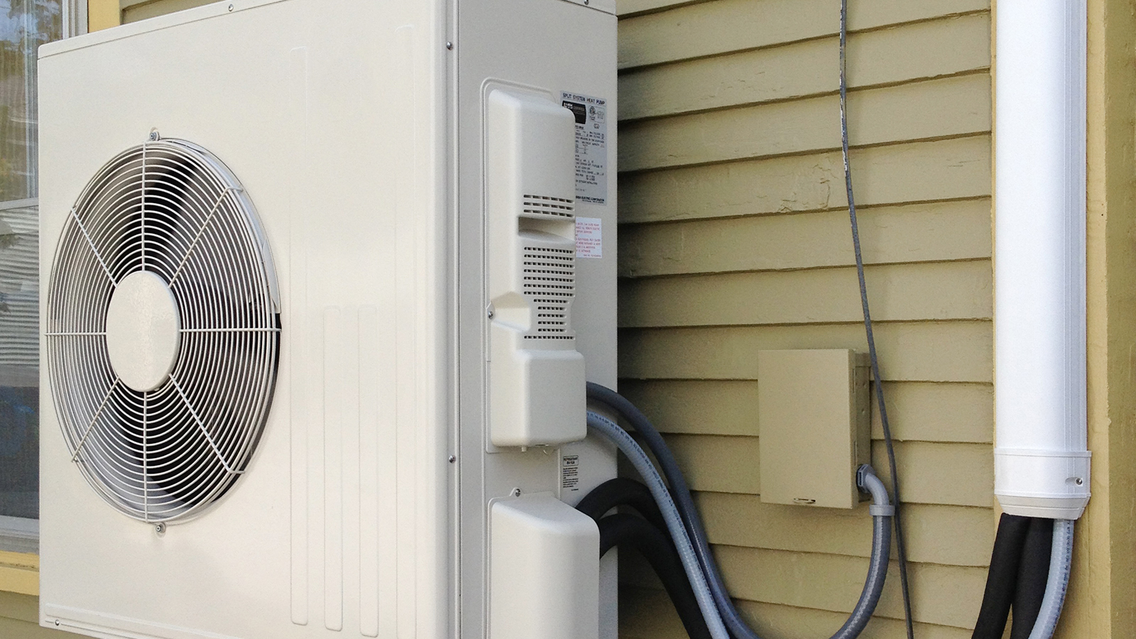 View of heat pump unit on the exterior of a house