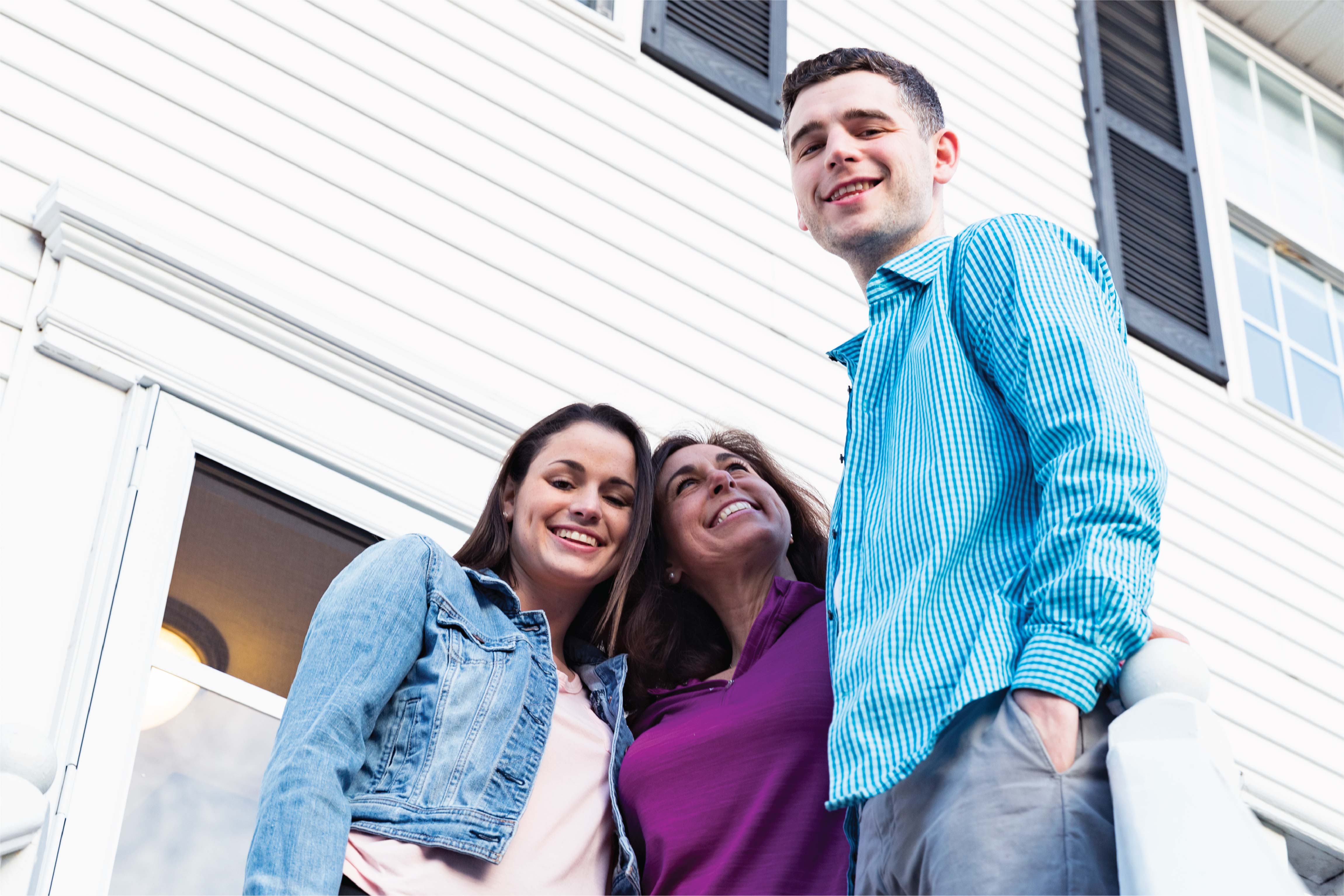 A photo of a family in front of their house